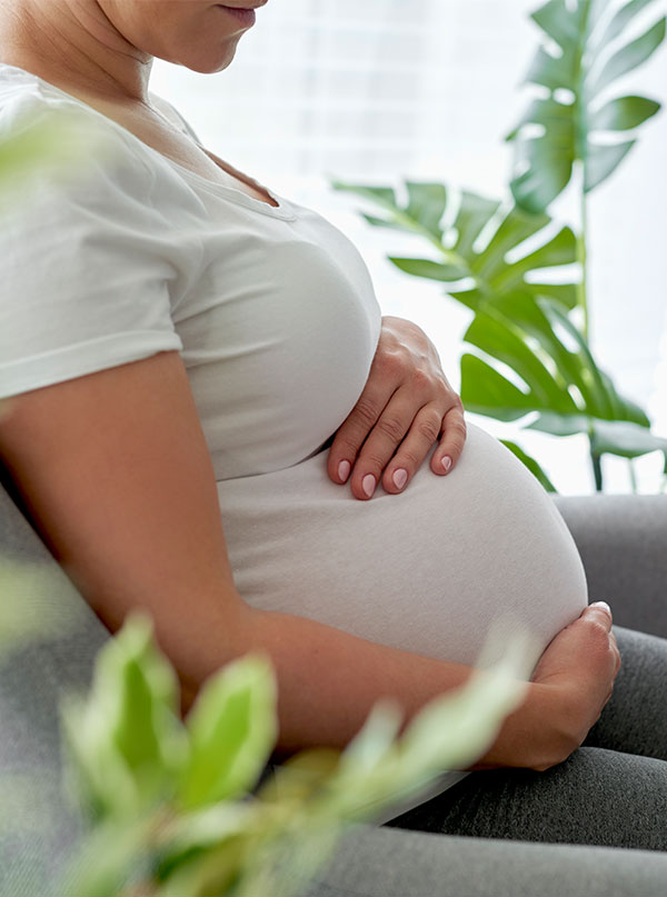 pregnant woman dealing with prenatal mental health holding her belly